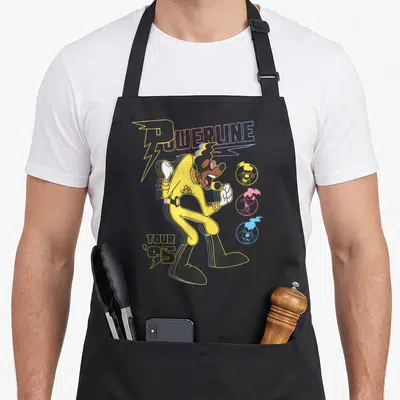 Powerline movie poster apron - Cartoon dog singer with POWERLINE TOUR '95 text and three colored portrait circles — shown on a black cotton canvas apron against a white background