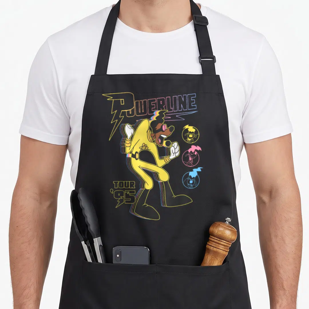 Powerline movie poster apron - Cartoon dog singer with POWERLINE TOUR '95 text and three colored portrait circles — shown on a black cotton canvas apron against a white background