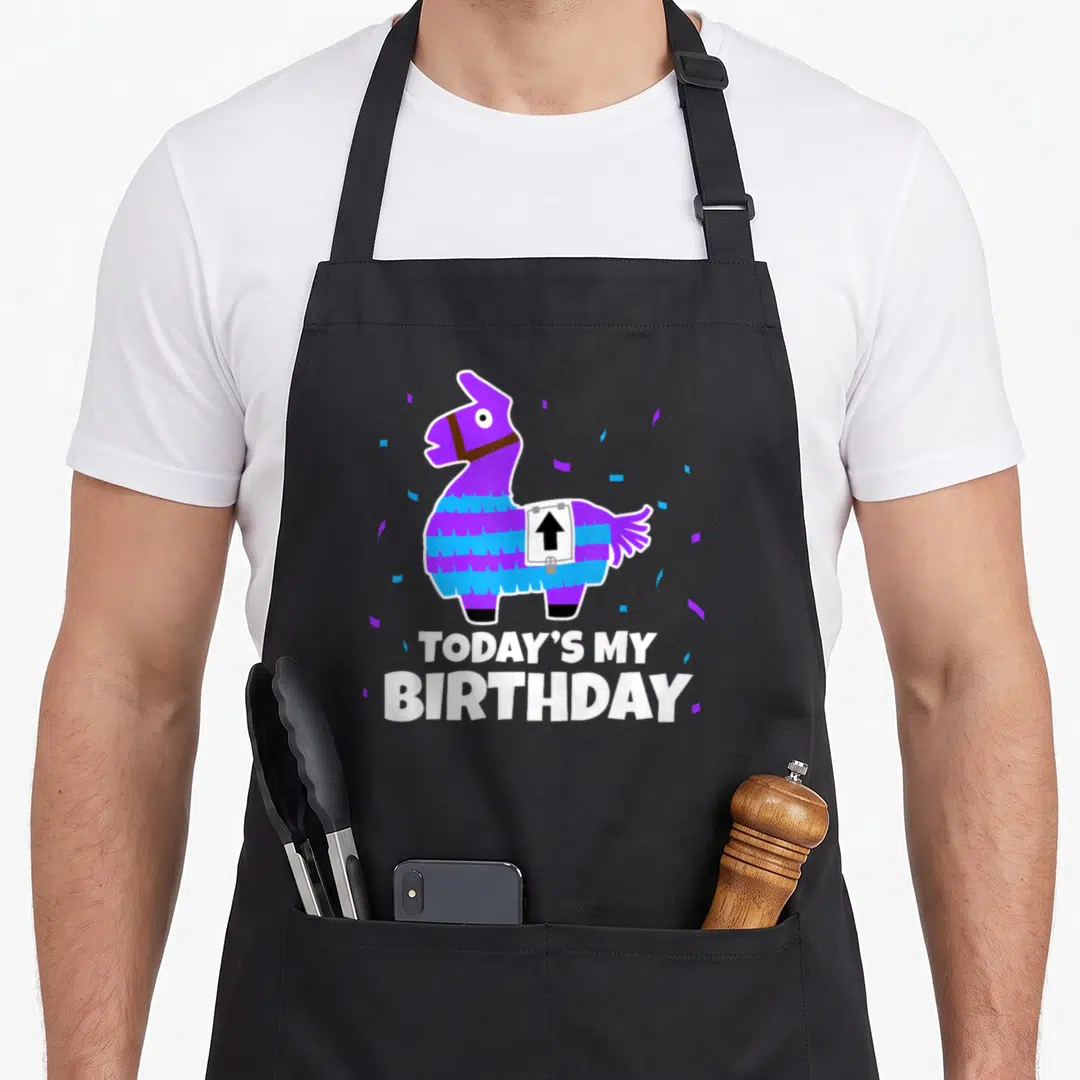 Animal birthday apron - Purple piñata llama with confetti and TODAY'S MY BIRTHDAY text — shown on a black cotton canvas apron against a white background