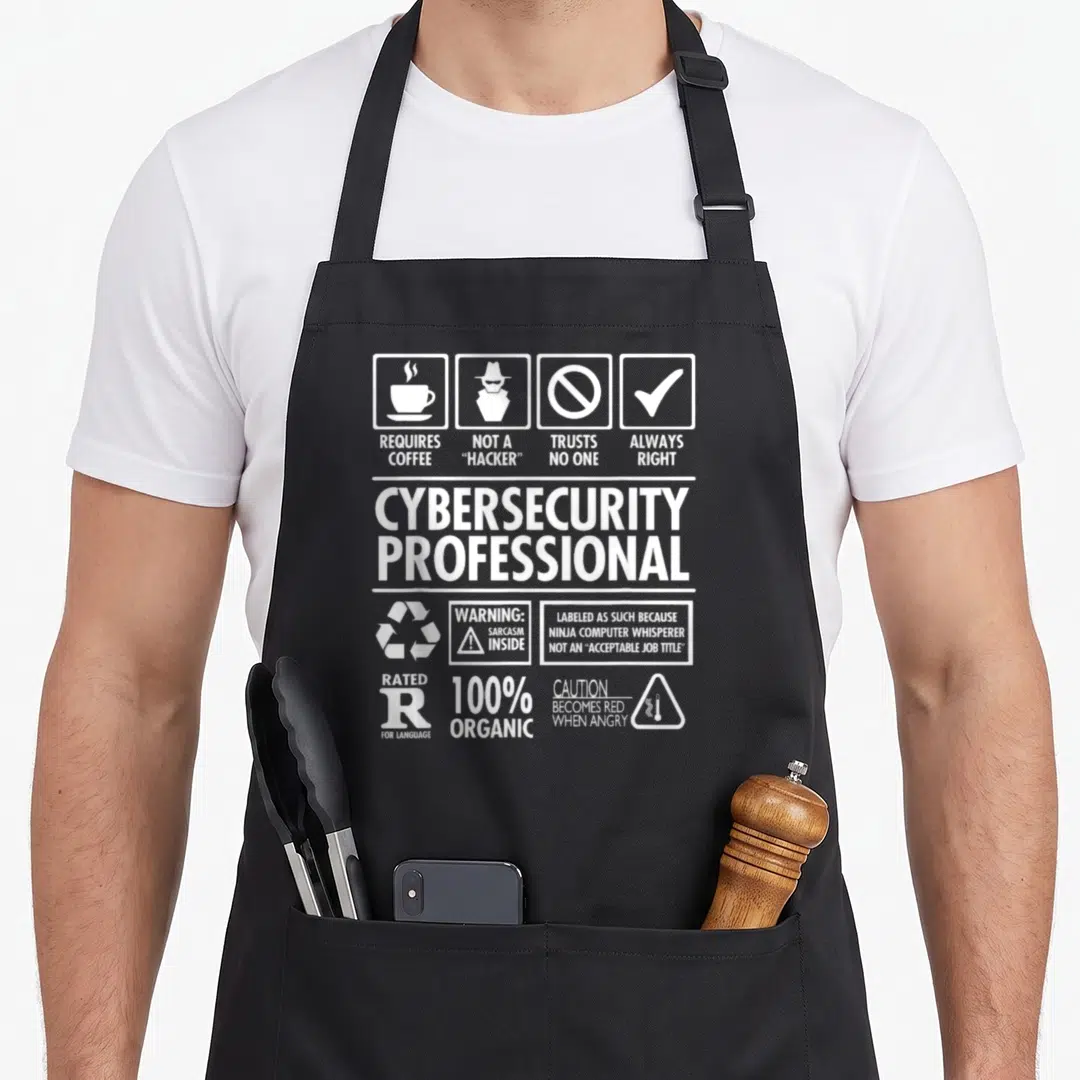 Nerdshizzle professional aprons - White typography design listing cybersecurity traits like requires coffee and not — shown on a black cotton canvas apron against a white background