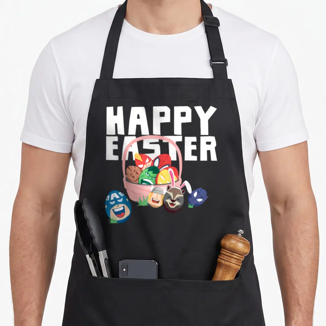 Easter basket apron - HAPPY EASTER text above pink basket with character eggs on grass — shown on a black cotton canvas apron against a white background