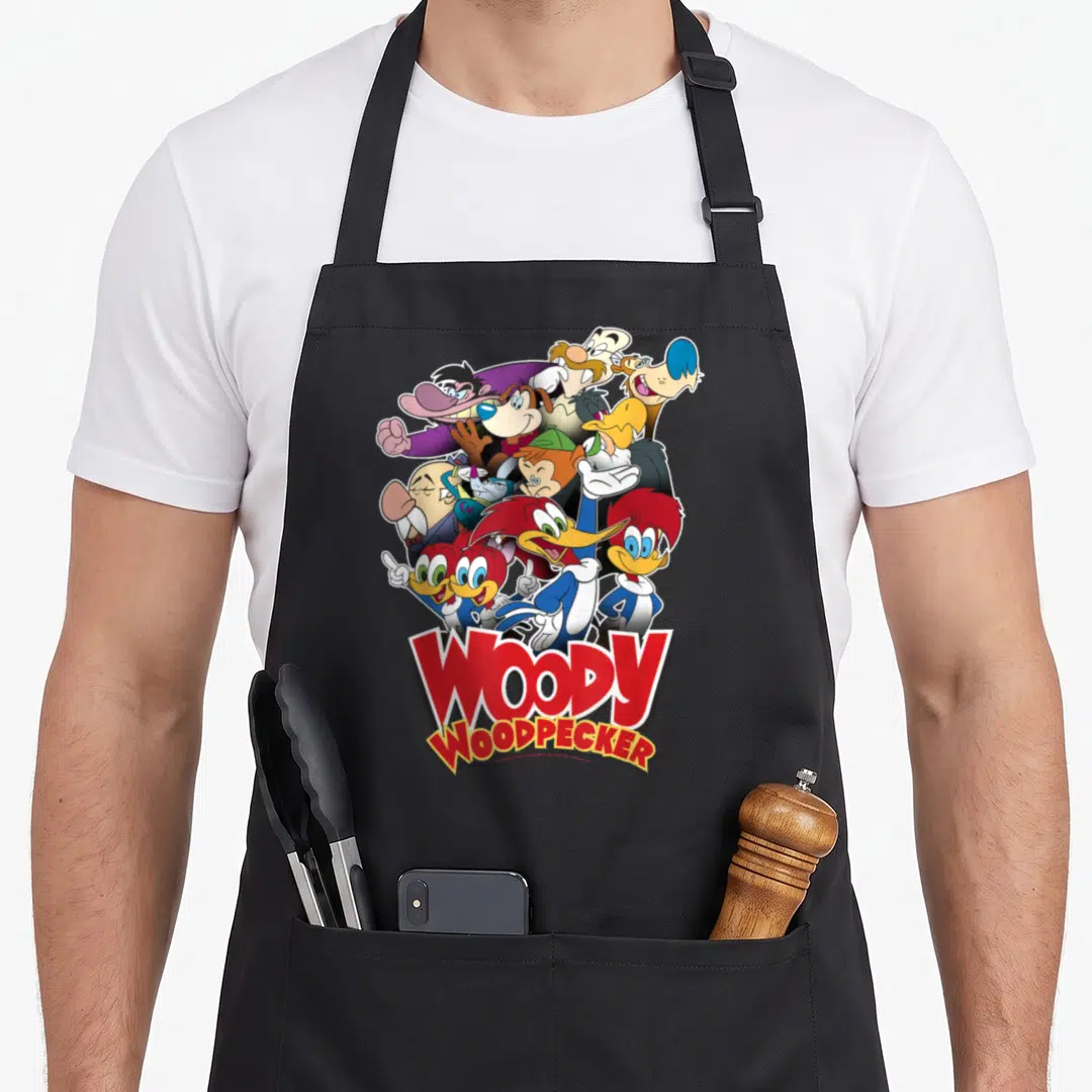 Shot woodpecker apron - Cartoon group cluster above stacked red WOODY WOODPECKER text with white outlines — shown on a black cotton canvas apron against a white background