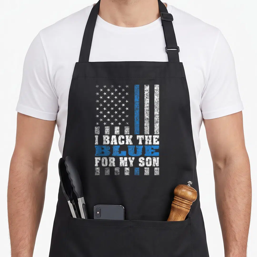Blue proud dad and son aprons - Distressed flag with I BACK THE BLUE FOR MY SON text in blue and white — shown on a black cotton canvas apron against a white background