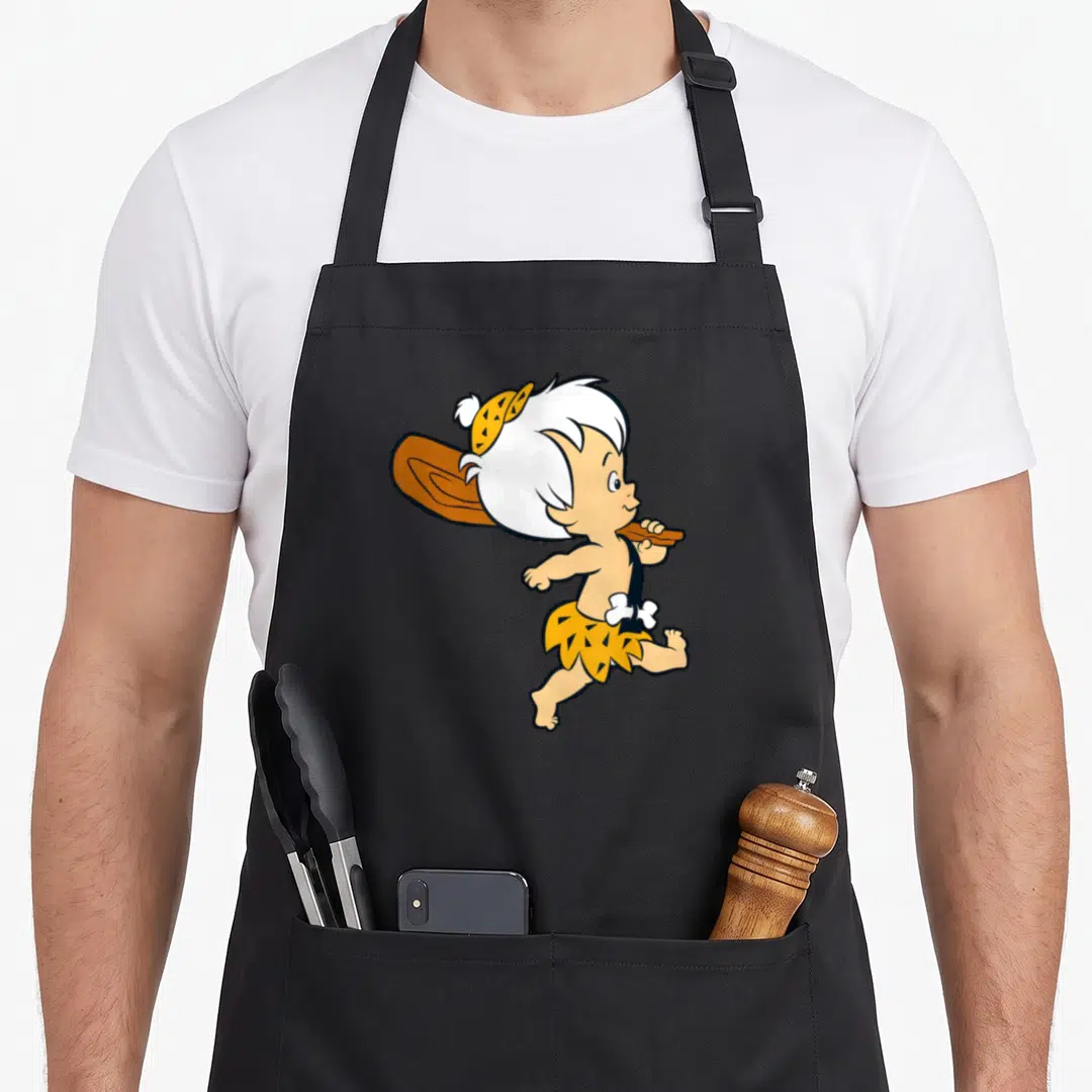 Bamm flint apron - Cartoon caveman child running with club in yellow brown and tan — shown on a black cotton canvas apron against a white background