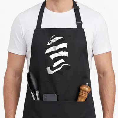 Escher novelty apron - Spiraling ribbon forming a face with Escher script text below — shown on a black cotton canvas apron against a white background