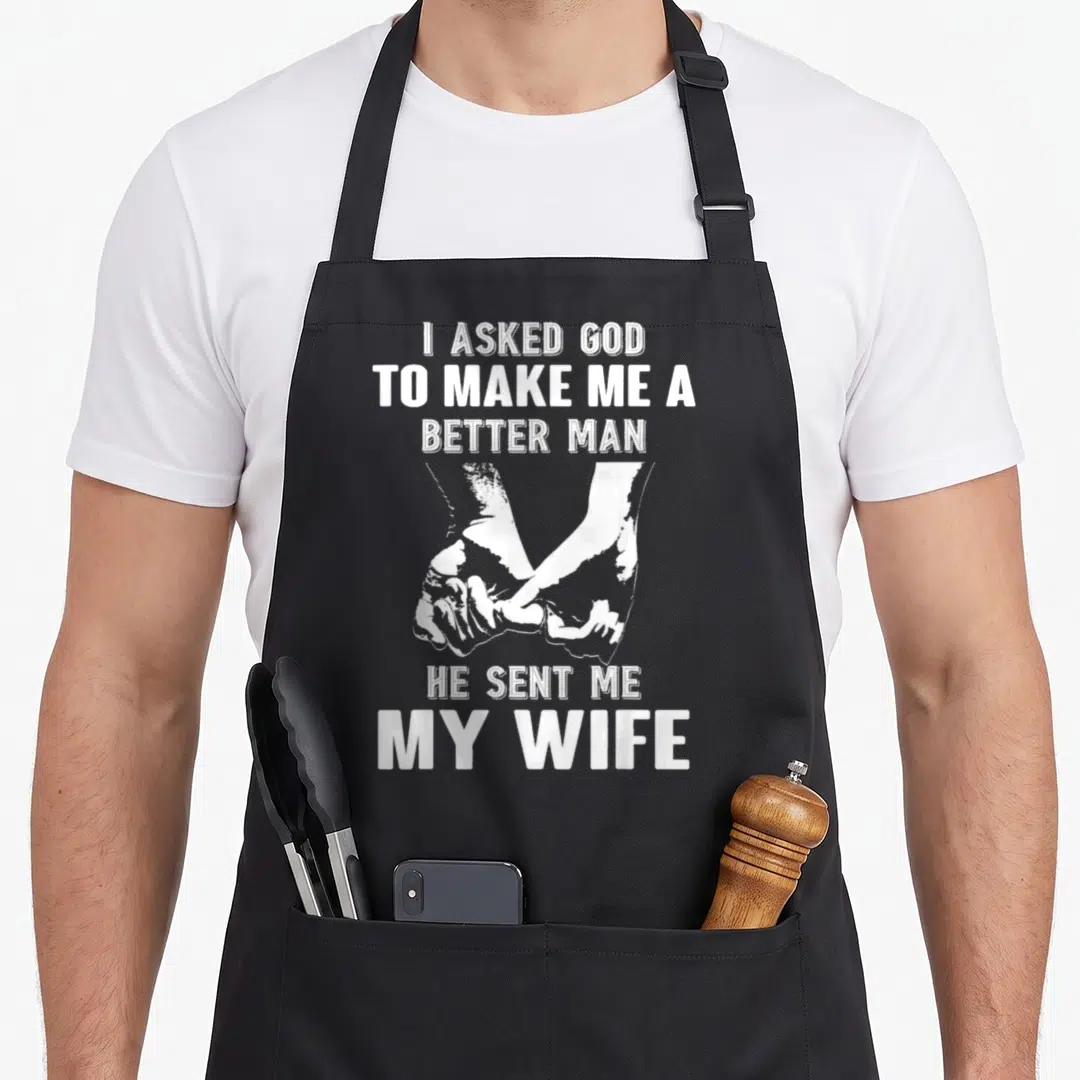 Asked wife apron - White distressed text and two hands holding, three lines above, two below, on black bib apron — shown on a black cotton canvas apron against a white background