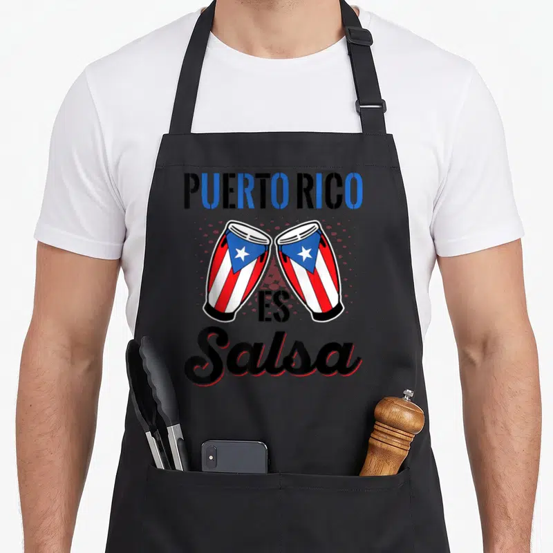 Music pride apron - PUERTO RICO ES Salsa text above two red white and blue conga drums in cartoon style — shown on a black cotton canvas apron against a white background