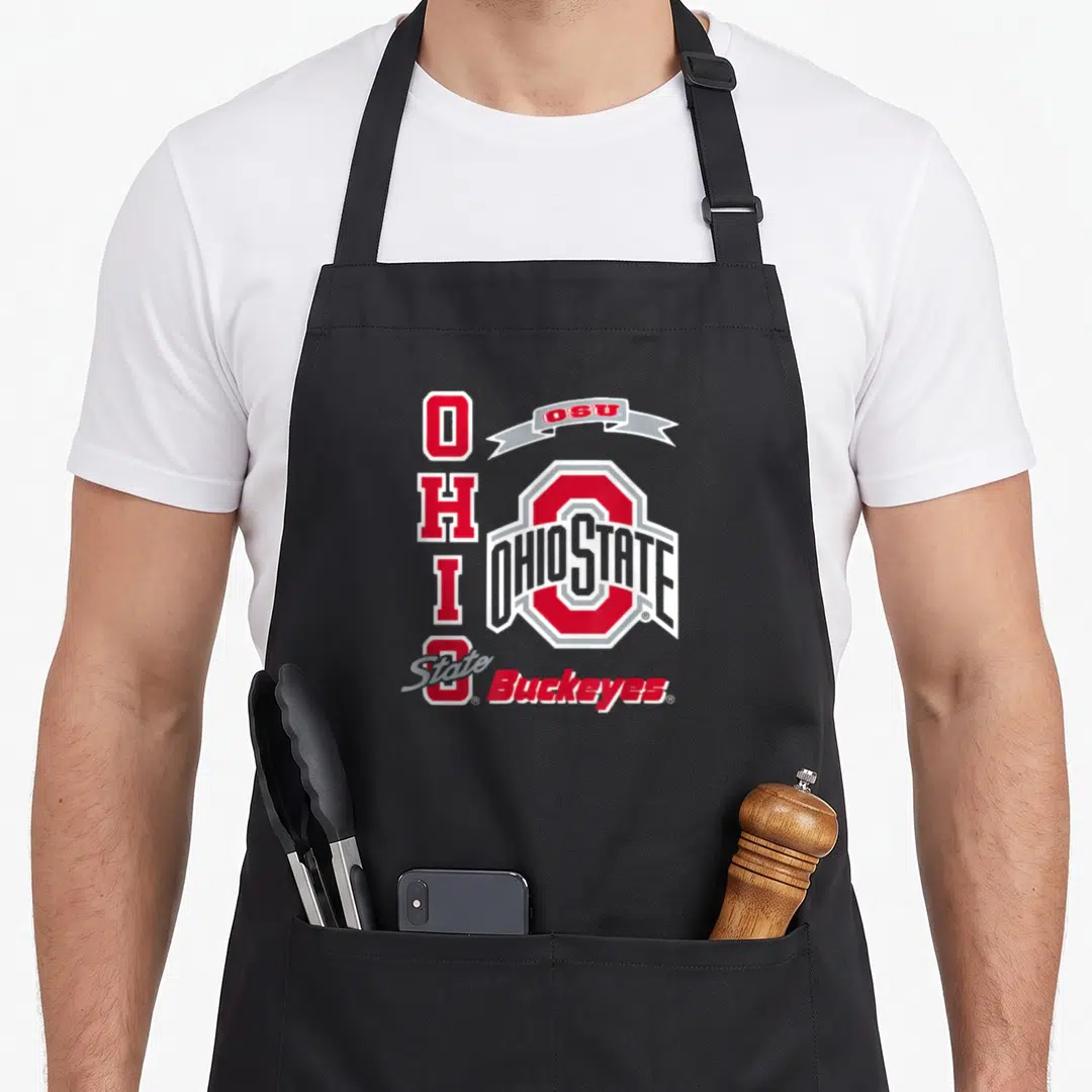 Cool buckeye apron - Red white and grey Ohio State logo with vertical OHIO text and OSU ribbon banner — shown on a black cotton canvas apron against a white background
