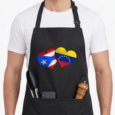 Rico venezuela pride apron - Two overlapping hearts with distressed Puerto Rican and Venezuelan flag colors red white — shown on a black cotton canvas apron against a white background