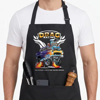 Bracket car apron - Cartoon blue yellow drag racer with flames and DRAG RACING text — shown on a black cotton canvas apron against a white background