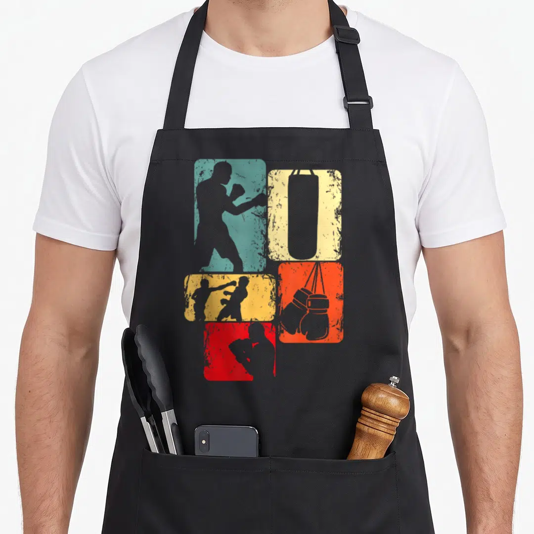 Boxer boxing apron - Four distressed teal, yellow, red, and grey rectangles with boxer, bag, and glove silhouettes — shown on a black cotton canvas apron against a white background
