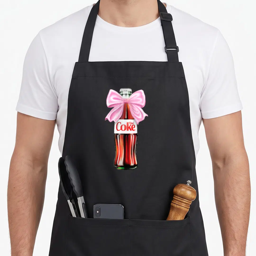 Diet bow apron - Realistic soda bottle with pink bow and Diet Coke label text — shown on a black cotton canvas apron against a white background