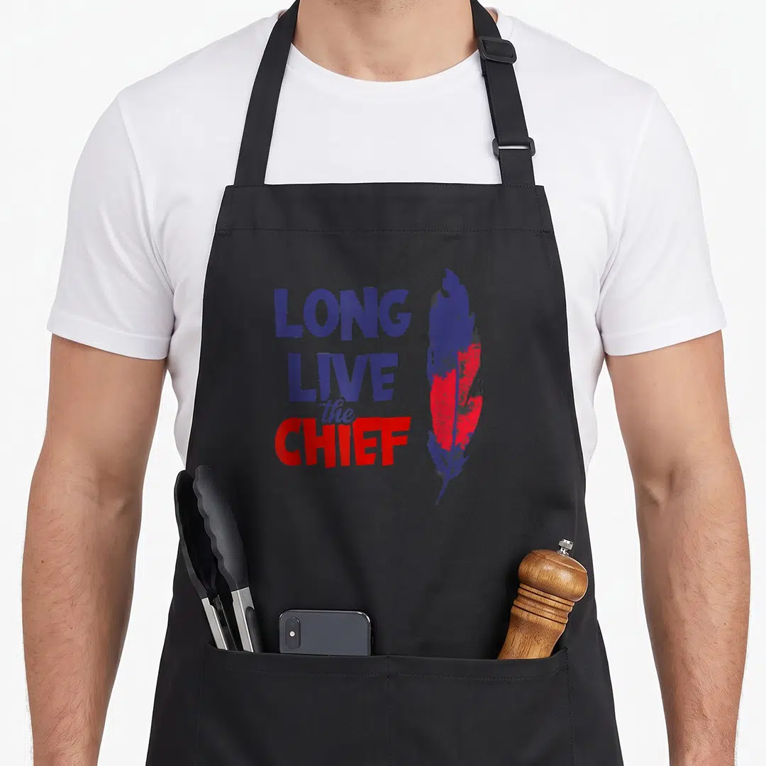 Live chiefs apron - Stacked Long Live The Chief text next to a blue and red distressed feather — shown on a black cotton canvas apron against a white background