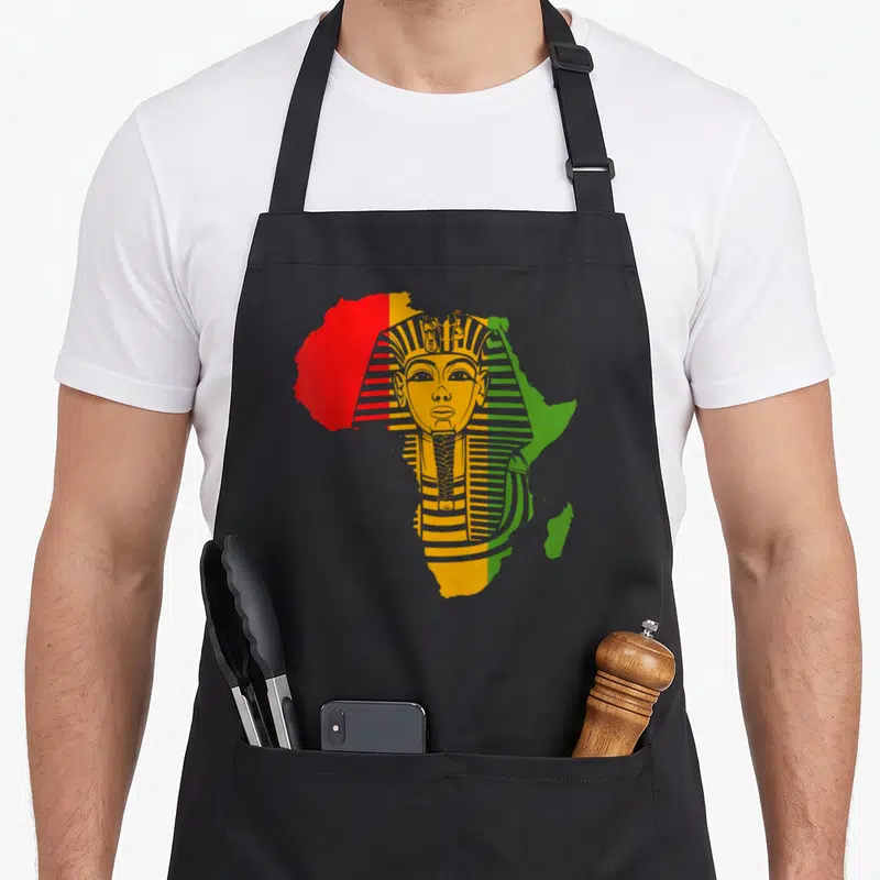 African egyptian apron - Pharaoh head over red yellow green Africa map on black apron — shown on a black cotton canvas apron against a white background