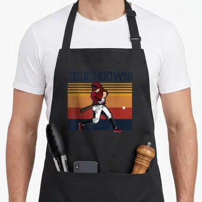 Baseball football apron - Retro baseball player swinging bat under TOUCHDOWN! text over blue orange yellow red white — shown on a black cotton canvas apron against a white background