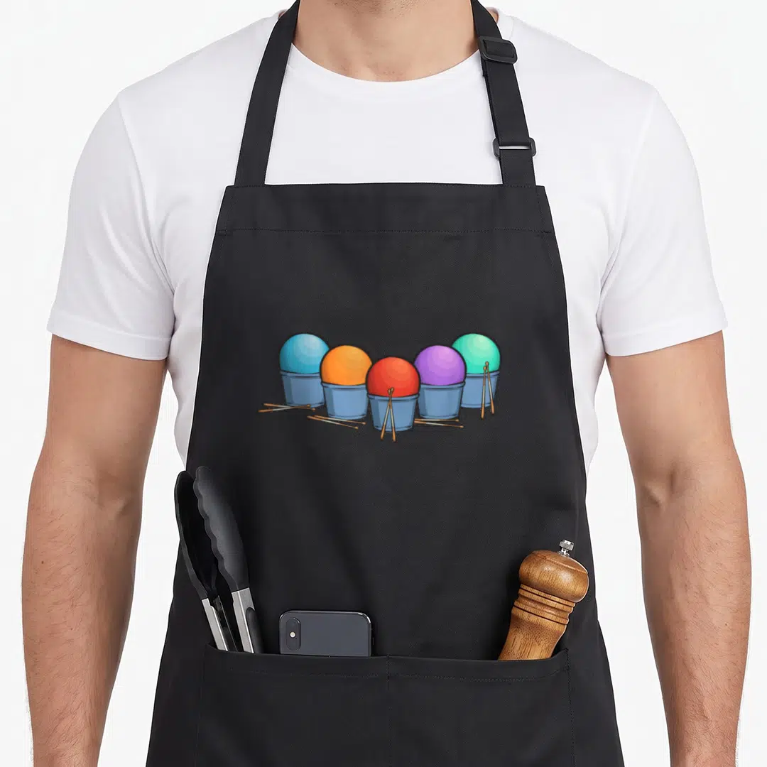 Cardio gym class apron - Five buckets with blue, orange, red, purple, and teal balls and scattered drumsticks — shown on a black cotton canvas apron against a white background