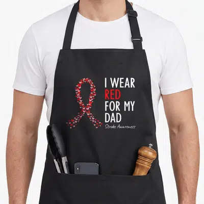 Warrior stroke awareness apron - Butterfly awareness ribbon and I Wear Red For My Dad text in red and white — shown on a black cotton canvas apron against a white background