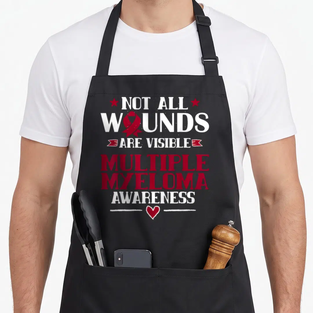Plasma blood apron - Red ribbon inside Wounds text with Multiple Myeloma Awareness lettering and heart — shown on a black cotton canvas apron against a white background