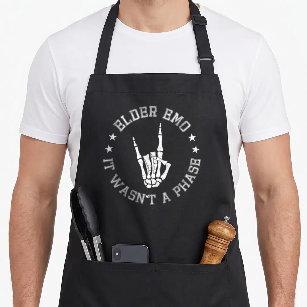 Phase emo apron - White skeleton hand rock-on sign with arched text ELDER EMO IT WASN'T A PHASE — shown on a black cotton canvas apron against a white background