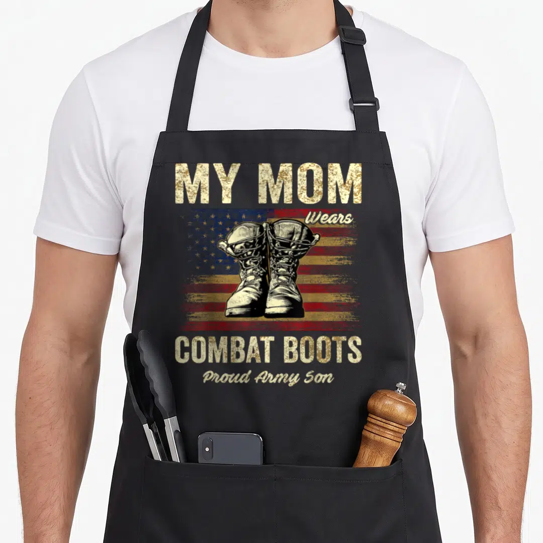 Combat mom and son aprons - Distressed flag background with combat boots and My Mom Wears Combat Boots text — shown on a black cotton canvas apron against a white background