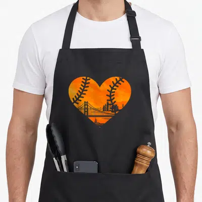 State baseball apron - Orange watercolor heart with grey bridge skyline and baseball stitching patterns — shown on a black cotton canvas apron against a white background