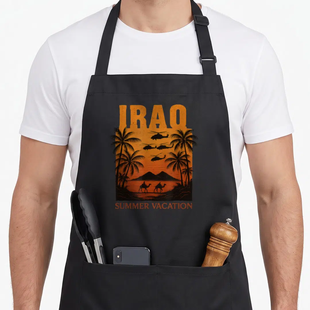 Iraq summer aprons - Retro orange and black print showing helicopters, palm trees, and camels with text IRAQ SUMMER — shown on a black cotton canvas apron against a white background