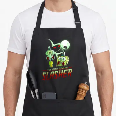 Squarepant spooky apron - Ghost holding spatula behind SpongeBob and Squidward with dripping red text — shown on a black cotton canvas apron against a white background