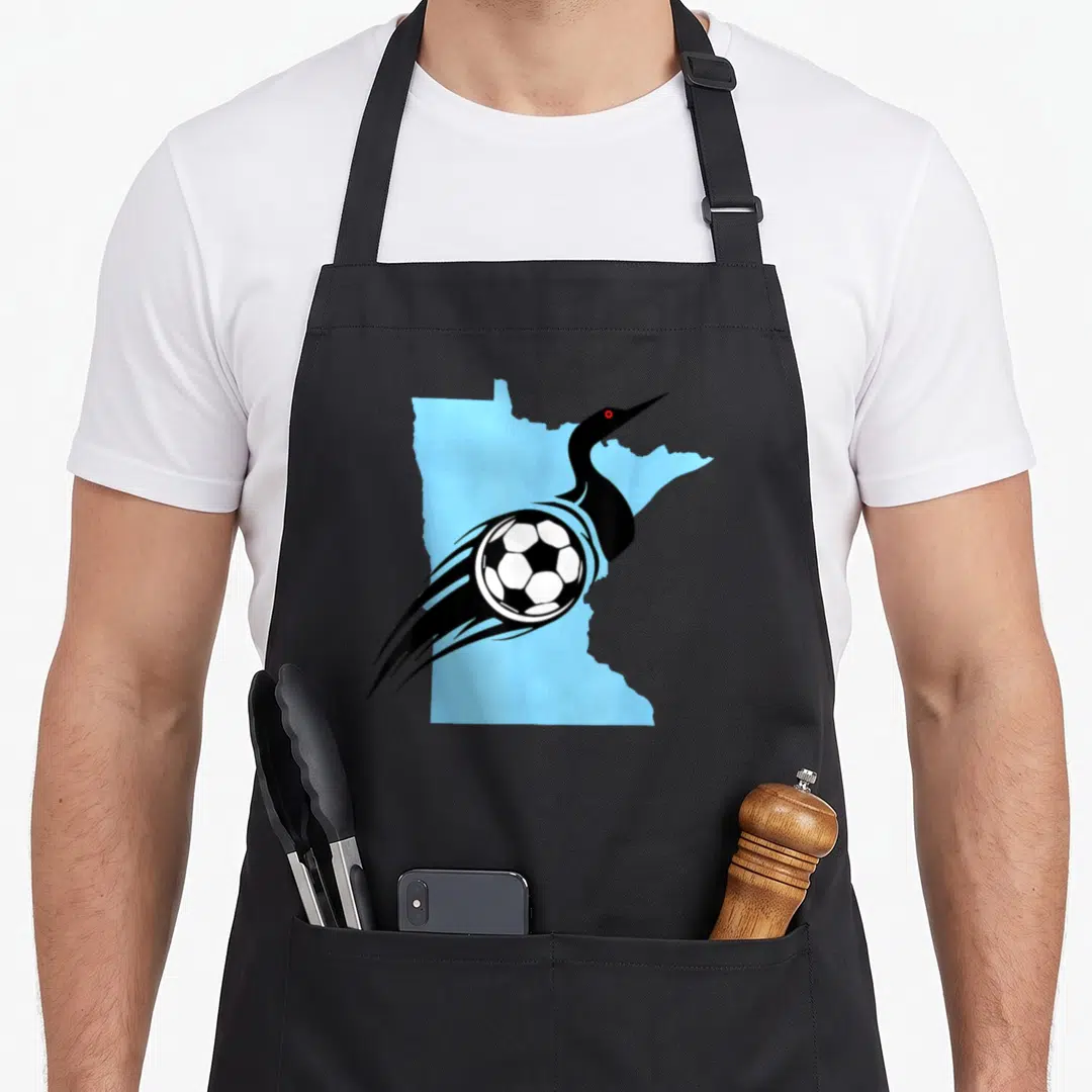 Soccer minnesota apron - Minimalist black loon over light blue Minnesota state map with soccer ball and motion lines — shown on a black cotton canvas apron against a white background