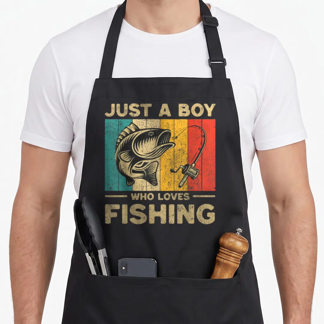 Joke fishing aprons - Retro fish and rod graphic with three colored stripes and printed text — shown on a black cotton canvas apron against a white background
