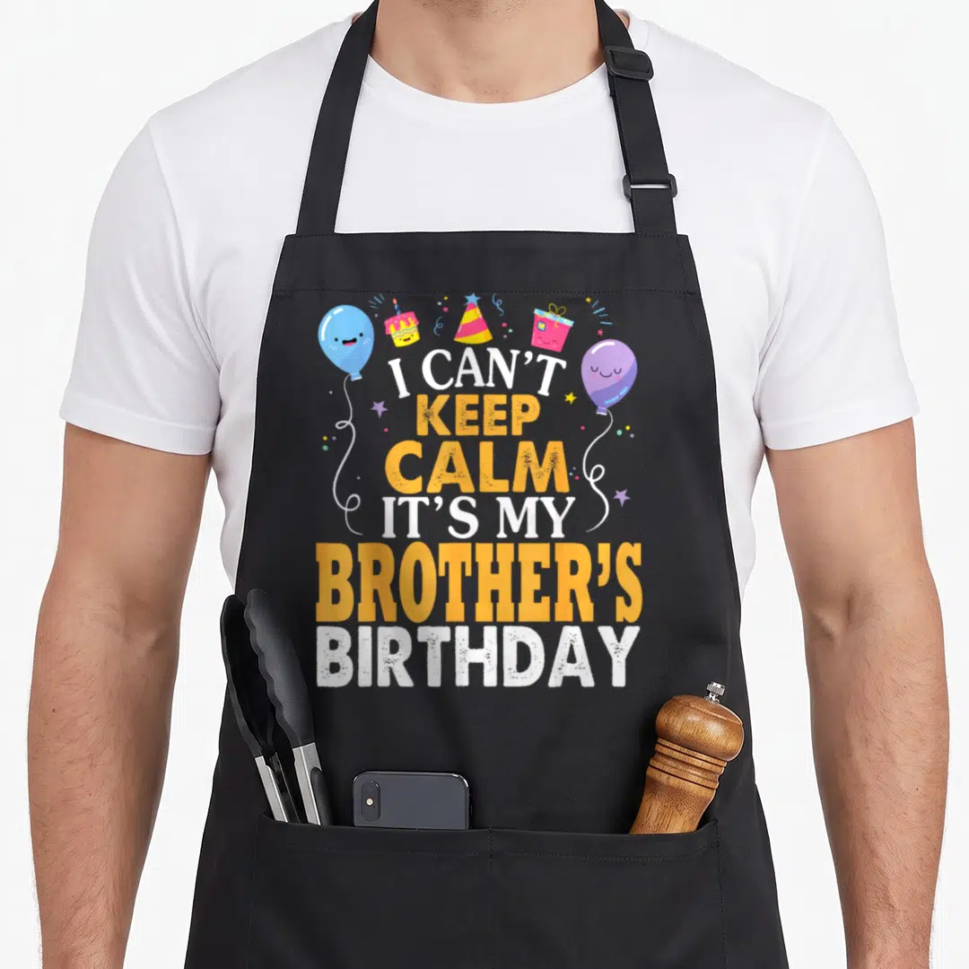 Vintage brother birthday apron - I Can't Keep Calm It's My Brother's Birthday text with cartoon balloons and gifts — shown on a black cotton canvas apron against a white background