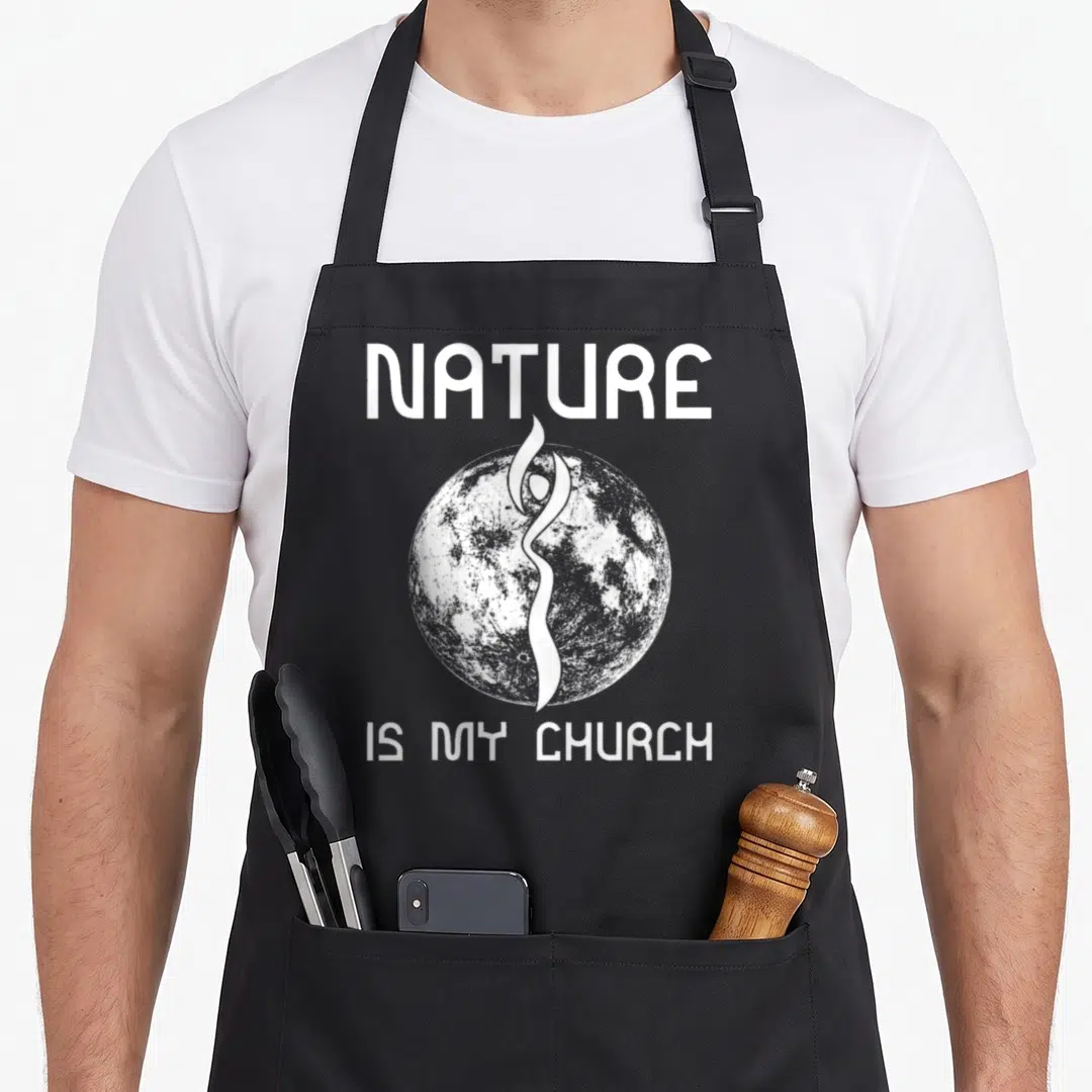 Nature church aprons - White NATURE IS MY CHURCH text framing a grey moon with a central stylized human silhouette — shown on a black cotton canvas apron against a white background