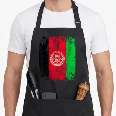 Flag afghan apron - Distressed black red and green flag with white mosque emblem on black bib apron — shown on a black cotton canvas apron against a white background