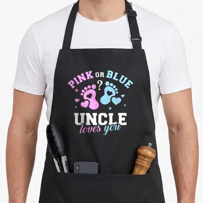 Gender uncle apron - Pink and blue footprints with PINK OR BLUE UNCLE loves you text — shown on a black cotton canvas apron against a white background