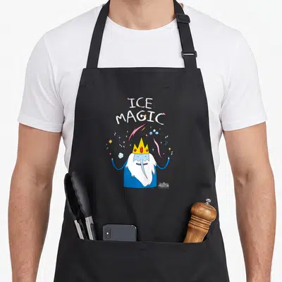 Adventure magic apron - Cartoon wizard with yellow crown and red gems under stacked ICE MAGIC text surrounded — shown on a black cotton canvas apron against a white background