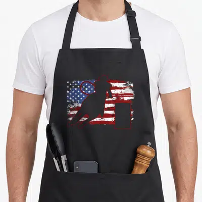 Vintage barrel racing apron - Red outline of woman with lasso and barrel over distressed USA flag — shown on a black cotton canvas apron against a white background