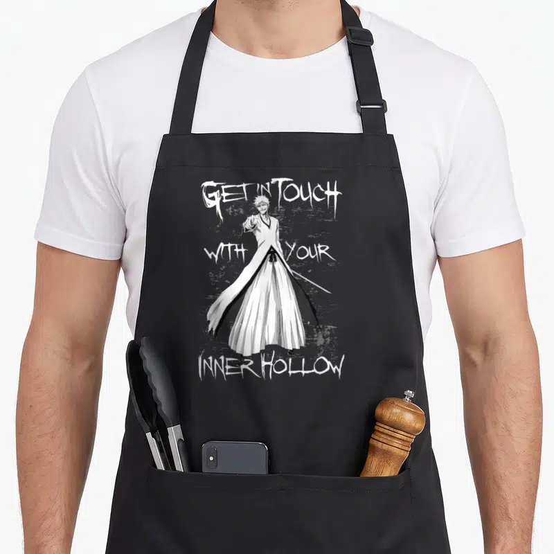 Soul anime apron - Line art of a man in a white robe holding a sword surrounded by three text sections reading GET — shown on a black cotton canvas apron against a white background