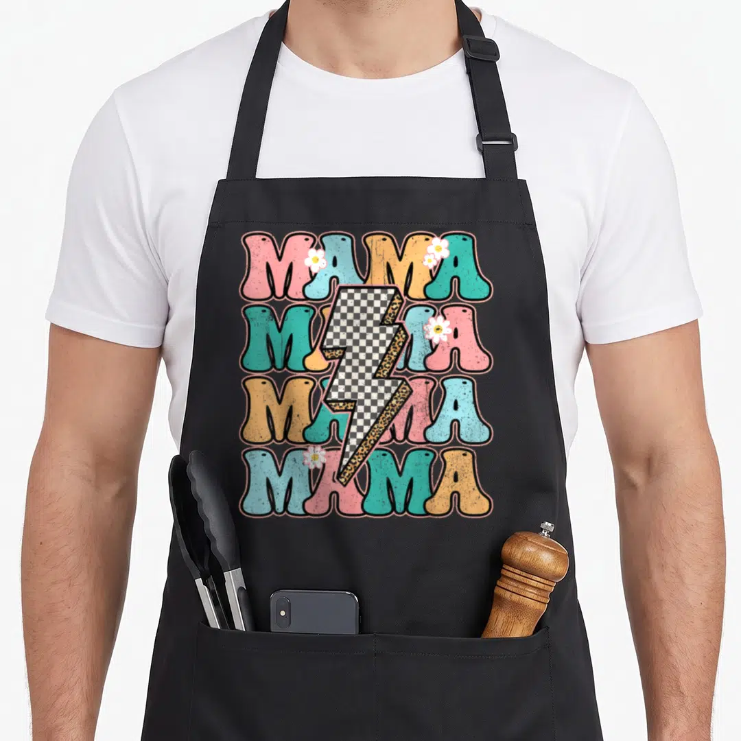 Checkered mother's day aprons - Retro MAMA text stack with checkered lightning bolt and flowers in pink cyan orange — shown on a black cotton canvas apron against a white background