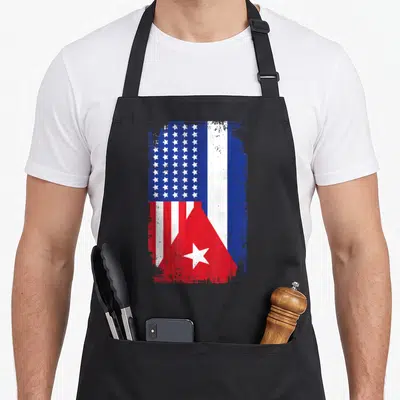Funny cuba american flag apron - Combined US and Cuban flags with distressed red white and blue paint splatter texture — shown on a black cotton canvas apron against a white background