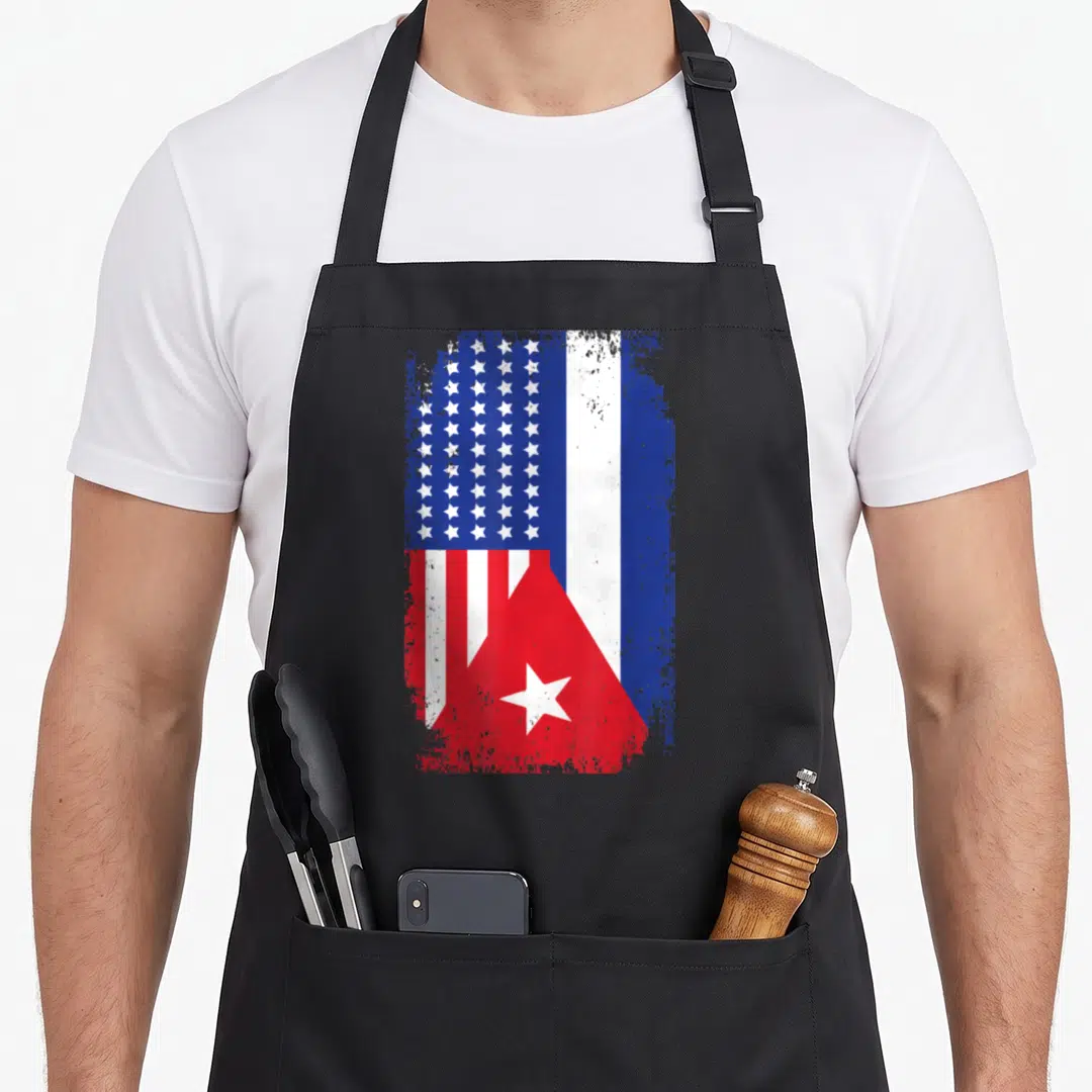 Funny cuba american flag apron - Combined US and Cuban flags with distressed red white and blue paint splatter texture — shown on a black cotton canvas apron against a white background