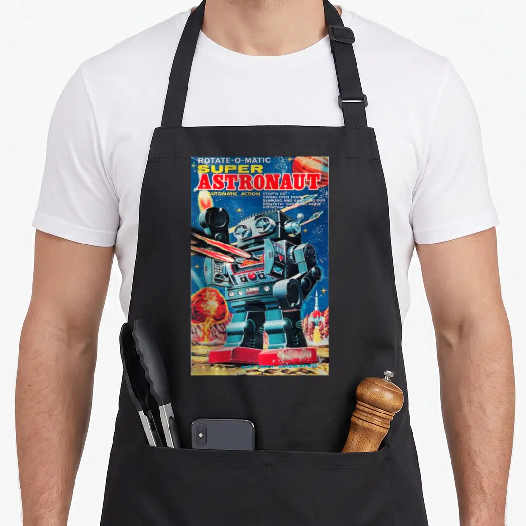 Astronaut robot apron - Vintage robot firing lasers with text listing automatic action and shooting gun features — shown on a black cotton canvas apron against a white background