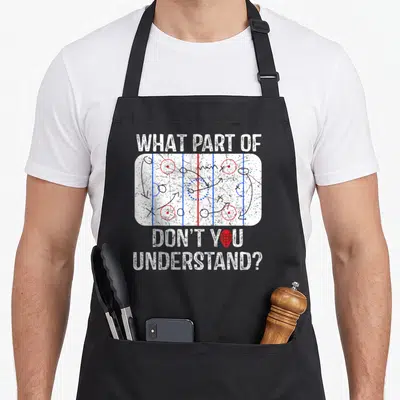 Coach parts of an apron - Hockey rink diagram with tactical arrows and text WHAT PART OF DON'T YOU UNDERSTAND? — shown on a black cotton canvas apron against a white background