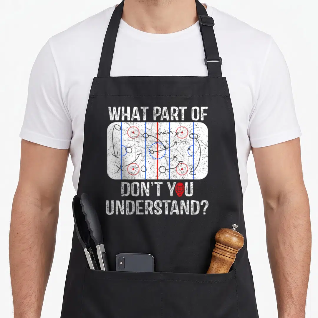 Coach parts of an apron - Hockey rink diagram with tactical arrows and text WHAT PART OF DON'T YOU UNDERSTAND? — shown on a black cotton canvas apron against a white background