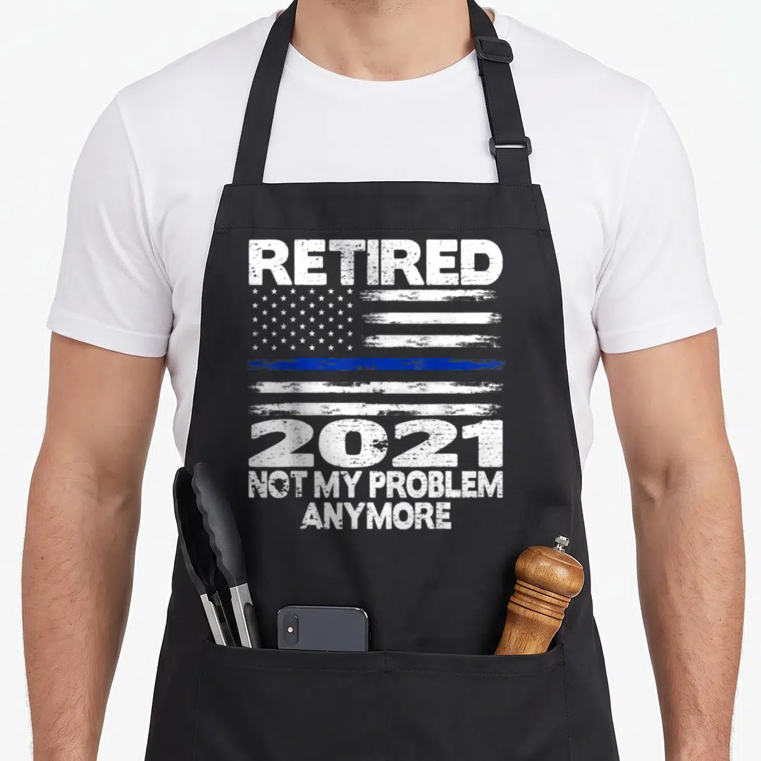 Police officer retirement apron - Distressed white and blue flag with thin blue line and text reading RETIRED 2021 NOT — shown on a black cotton canvas apron against a white background