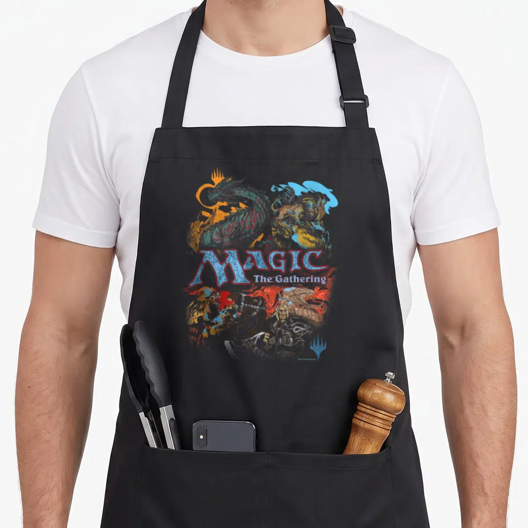 Iconic magic apron - Fantasy creatures surrounding MAGIC The Gathering text with a blue symbol at bottom right — shown on a black cotton canvas apron against a white background