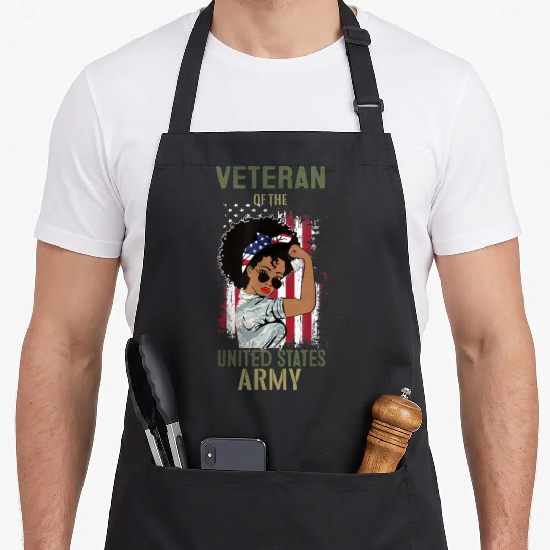 Army african american aprons - Female veteran in camo flexing arm with dog tags under VETERAN OF THE UNITED STATES ARMY — shown on a black cotton canvas apron against a white background