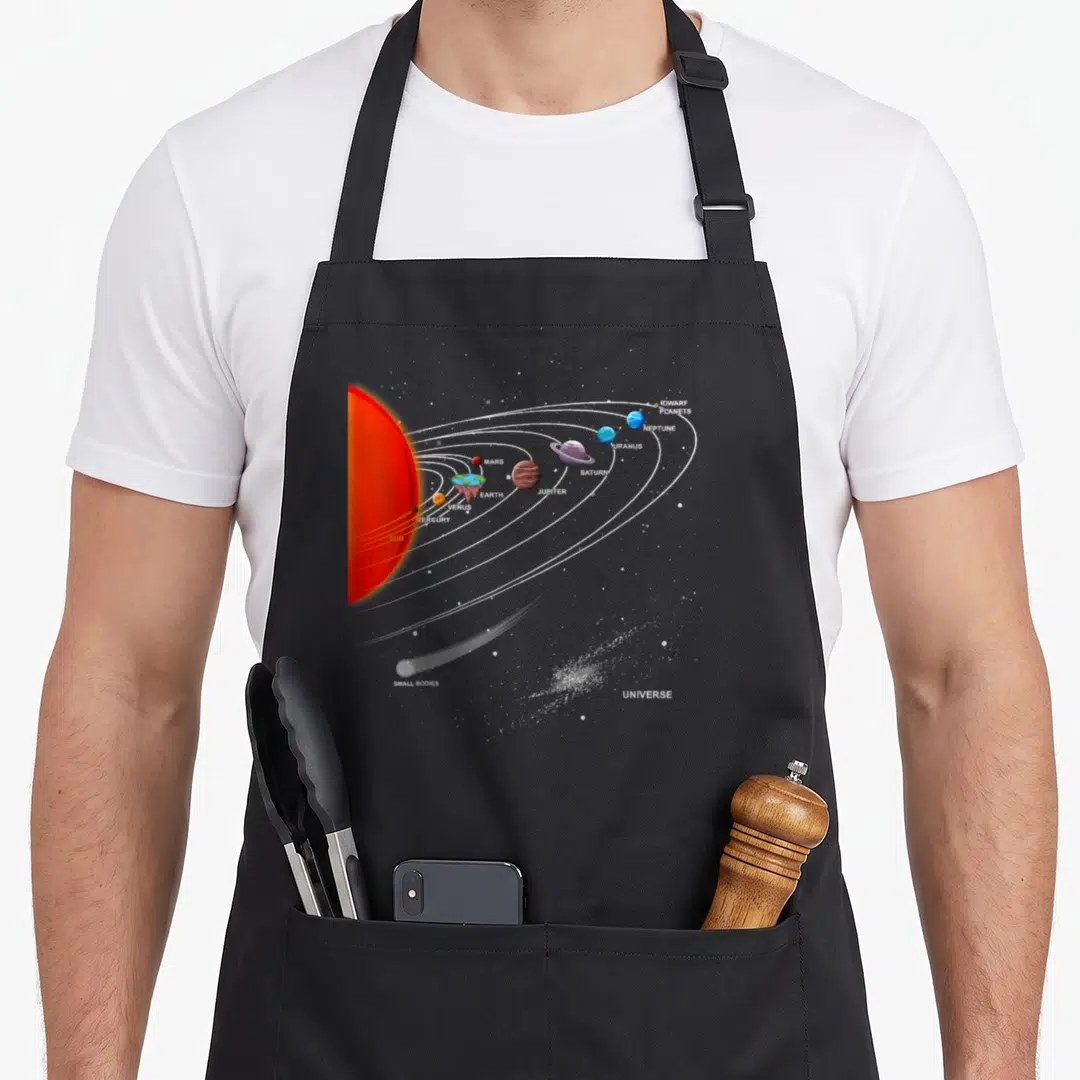 Earth joke apron - Flat Earth solar system diagram with labeled planets and white orbits on grey background — shown on a black cotton canvas apron against a white background