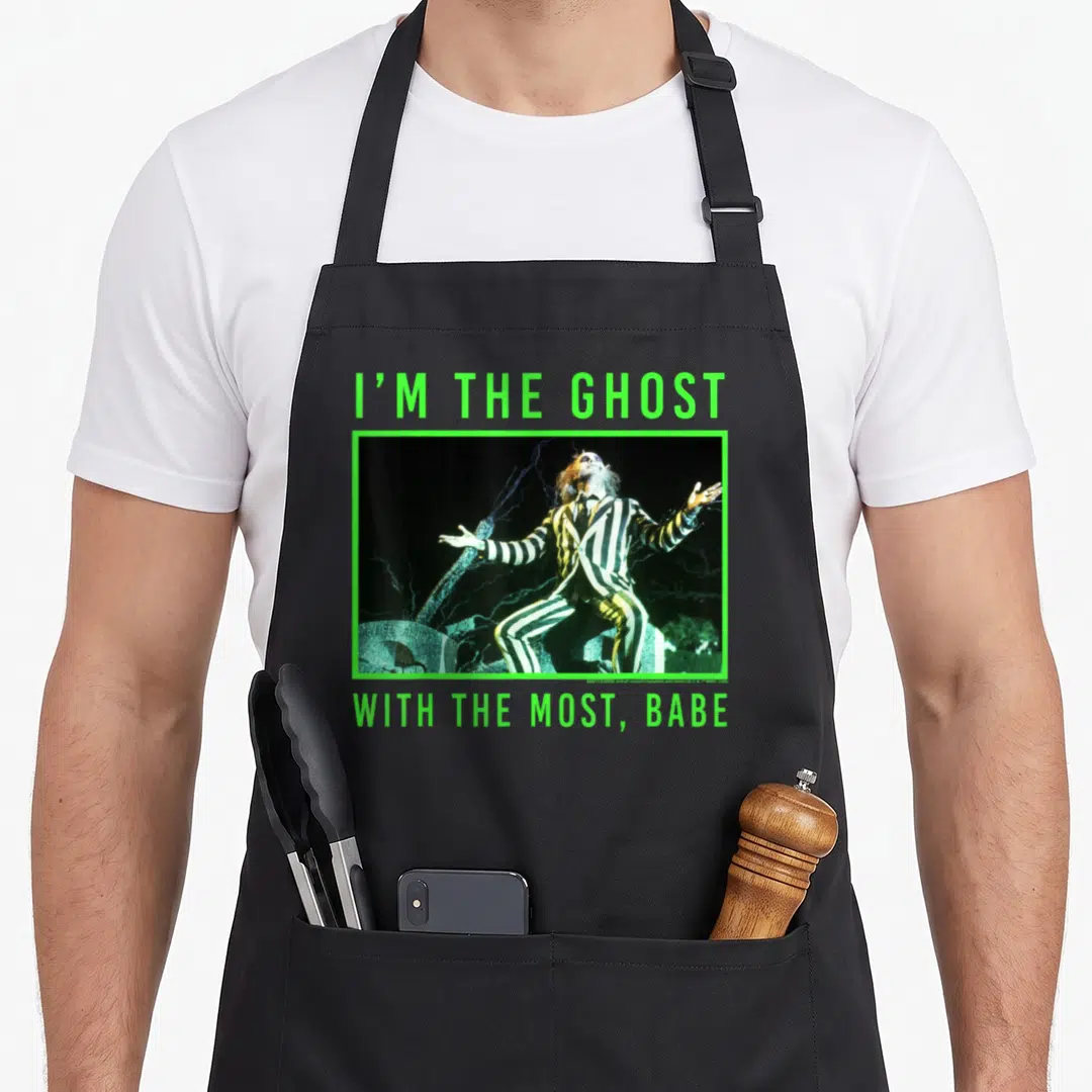 Most ghost apron - Beetlejuice photo in lime green frame with text I'M THE GHOST WITH THE MOST BABE — shown on a black cotton canvas apron against a white background