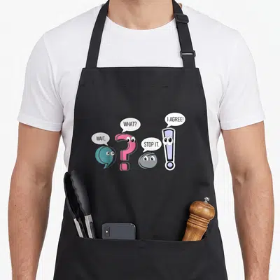Stop teacher apron - Cartoon comma, question mark, period, and exclamation point with speech bubbles reading WAIT — shown on a black cotton canvas apron against a white background