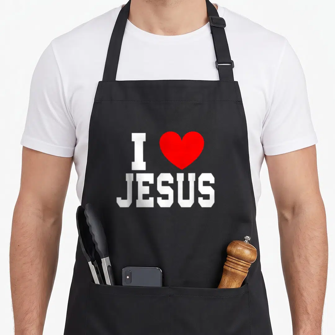 Faith i love goer apron - White I JESUS text with red heart symbol on grey background — shown on a black cotton canvas apron against a white background