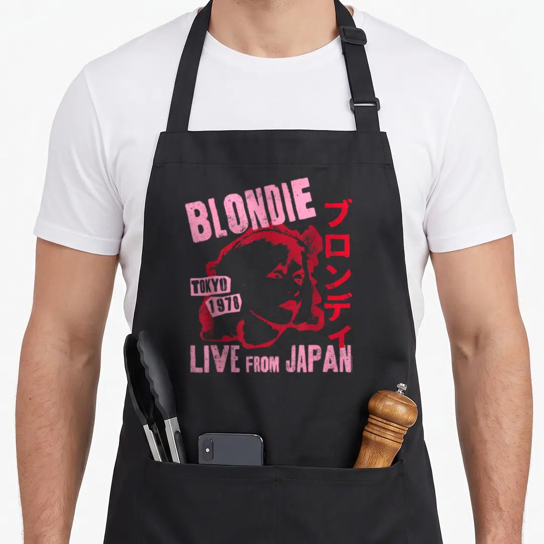 Blondie japan apron - Distressed pink Blondie portrait with Tokyo 1978 text and vertical Japanese characters — shown on a black cotton canvas apron against a white background
